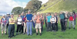  ??  ?? ●● Buxton’s very own Angel of the North – Ramblers at Curbar Cross