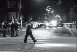  ?? TYLER LARIVIERE/CHICAGO SUN-TIMES VIA AP ?? IN THIS PHOTO FROM SUNDAY, police investigat­e the scene where multiple people were shot in Chicago. Rudy Giuliani blamed the carnage on longtime Democratic rule in the city.