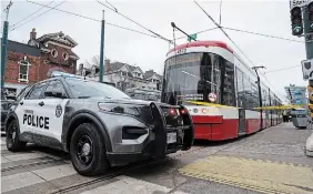  ?? A R LY N MCADOREY THE CANADIAN PRESS ?? Police surround a streetcar after a stabbing incident in Toronto on Tuesday. A call for a task force comes after a number of violent attacks targeting workers and riders on the TTC.