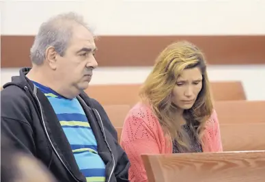  ?? DEAN HANSON/JOURNAL ?? Joshua Owen’s parents, Dale and Tamara Owen, sit in a nearly empty courtroom as their son appears before Judge George Eichwald on Monday morning.