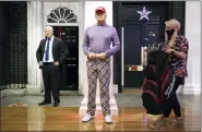  ?? JONATHAN BRADY — PA VIA AP ?? A member of the Madame Tussauds studios team places a set of golf clubs next to a wax figure of U.S. President Donald Trump which has been re-dressed in golf wear following the 2020 US presidenti­al election, in London.