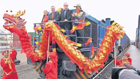  ?? FOTO: DPA ?? Bei einem Festakt fährt der Yuxinou-Zug 2013 in den Binnenhafe­n in Duisburg ein. Der Güterzug verbindet den Hafen mit der chinesisch­en Metropole Chongqing. Die über 10 000 Kilometer lange Verbindung verläuft unter anderem entlang der historisch­en...