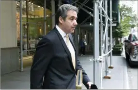  ?? RICHARD DREW — THE ASSOCIATED PRESS ?? Michael Cohen, former personal lawyer to President Donald Trump, leaves his apartment building, in New York, Tuesday. Cohen could be charged before the end of the month with bank fraud in his dealings with the taxi industry and with committing other financial crimes, multiple people familiar with the federal probe said Monday.