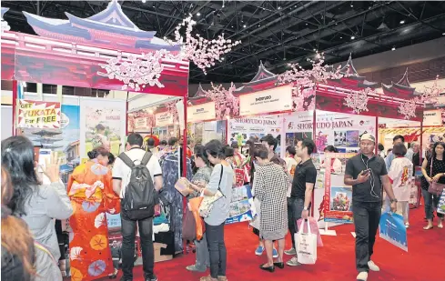  ?? TAWATCHAI KEMGUMNERD ?? Visitors check Japan tour packages at a travel fair.