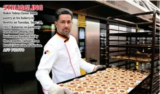  ?? AFP PHOTO ?? STRUGGLING Baker Tobias Exner holds pastry at his bakery in Beelitz on Tuesday, Sept. 20, 2022. Bakeries in Germany have been among the businesses hardest hit by the economic fallout from Russia’s invasion of Ukraine.