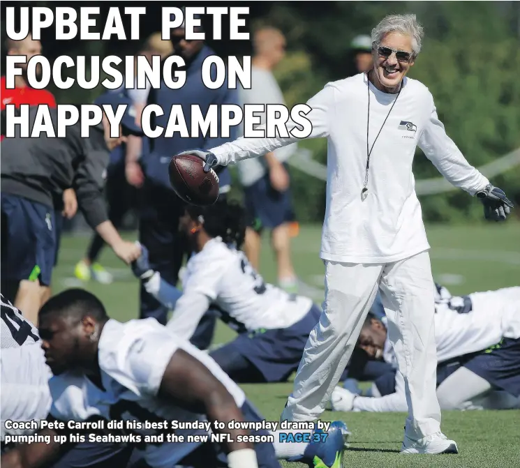  ?? — THE ASSOCIATED PRESS ?? Seahawks head coach Pete Carroll is all smiles on Sunday as his players stretch at Day 1 of training camp in Renton, Wash.