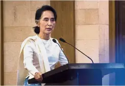  ?? — AFP ?? Ongoing struggle: Suu Kyi speaking during a memorial ceremony for Ko Ni and Ne Win in Yangon.