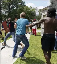  ?? THE ASSOCIATED PRESS ?? Protesters clash during a demonstrat­ion, Aug. 15, in Stone Mountain Village, Ga.