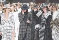  ??  ?? CARA DELEVINGNE and other models react while presenting creations by Karl Lagerfeld at the women’s RTW collection show for Chanel.