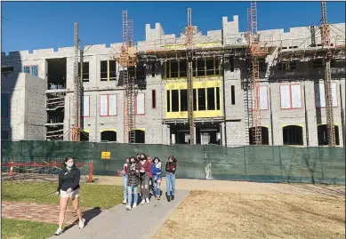  ?? (NWA Democrat-Gazette/Andy Shupe) ?? A group of visitors to the University of Arkansas campus is led on a tour Thursday as work continues on the Student Success Center on the university campus in Fayettevil­le. Millions of dollars that once went to local projects through checks doled out by state legislator­s now go to colleges, universiti­es and other state-run institutio­ns and are appropriat­ed by the Legislatur­e. Go to nwaonline. com/201122Dail­y/ for today’s photo gallery.