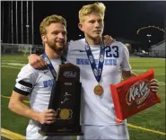  ?? AUSTIN HERTZOG — MEDIANEWS GROUP ?? North Penn captains Carter Houlihan, left, and Josh Jones pose with the PIAA championsh­ip trophy after the Knights’ win over Central Bucks West at Hersheypar­k Stadium in Hershey on Friday, Nov. 15, 2019.
