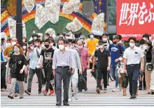  ?? AP-Yonhap ?? People wearing masks against the spread of the new coronaviru­s walk at Shibuya pedestrian crossing in Tokyo, Friday.