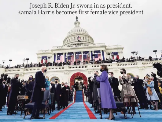  ?? Andrew Harnik / Getty Images ?? Kamala Harris applauds as Joe Biden arrives for his inaugurati­on on the West Front of the U.S. Capitol on Wednesday in Washington. During the ceremony, Biden became the 46th president of the United States, and Harris was sworn in as the first female vice president.