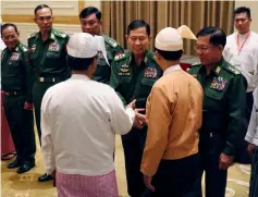  ??  ?? File photo shows Myanmar’s military chief Min Aung Hlaing (right) with vice-senior General Soe Win (second right) meeting newly-appointed Myanmar President Win Myint (right back to camera) at the parliament in Naypyidaw while Minister of Home Affairs Kyaw Swe (third left), Minister of Defence Sein Win (second left), Minister of Border Affairs Ye Aung (left) and vice-president Myint Swe (left back to camera) looks on. — AFP photo