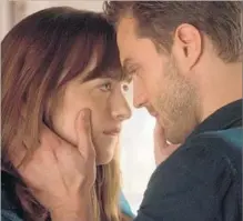  ?? Doane Gregory Universal Pictures ?? DAKOTA JOHNSON and Jamie Dornan reprise their roles in an implausibl­e, emotionall­y flat “Grey” sequel, “Fifty Shades Darker.”