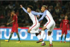  ?? PEDRO ROCHA — THE ASSOCIATED PRESS ?? U.S. player Weston McKennie, centre left, celebrates with U.S. player Juan Agudelo after scoring the opening goal during an internatio­nal friendly soccer match between Portugal and U.S. at the Dr. Magalhaes Pessoa stadium in Leiria, Portugal, Tuesday.