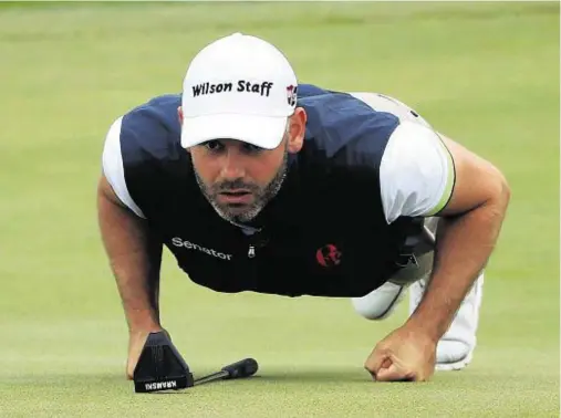  ??  ?? GETTING DOWN TO BUSINESS: Paul Waring lines up a putt during his round at the HNA Open de France yesterday