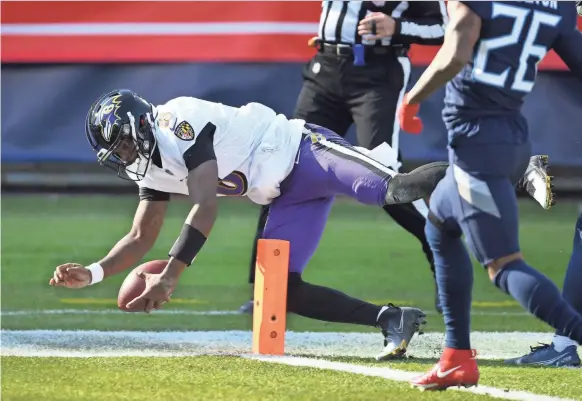  ?? CHRISTOPHE­R HANEWINCKE­L/USA TODAY SPORTS ?? Ravens quarterbac­k Lamar Jackson dives for a touchdown against the Titans during the AFC wild-card game Sunday.