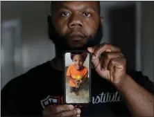  ?? PAUL SANCYA — THE ASSOCIATED PRESS ?? Leon Abdullah El-Alamin shows a photo of his son Leon Jr., in Mt. Morris Township, Mich., Jan. 13.