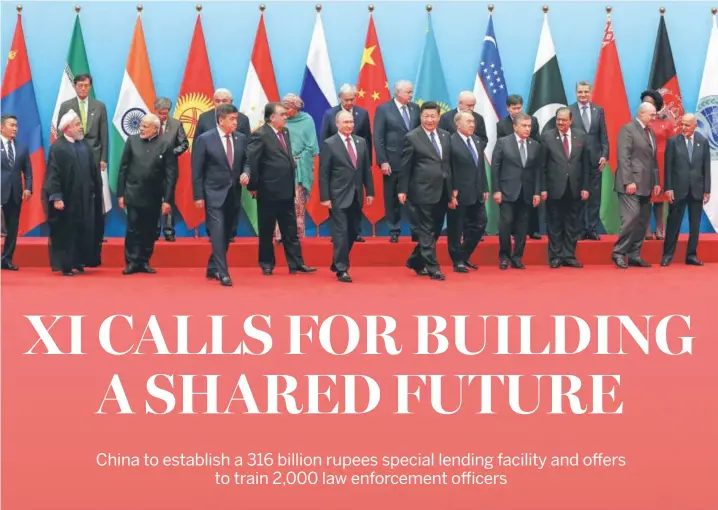  ?? XU JINGXING / CHINA DAILY ?? President Xi Jinping and leaders attending the 18th Shanghai Co-operation Organisati­on Summit pose for a group photo on June 10 in Qingdao, Shandong province.