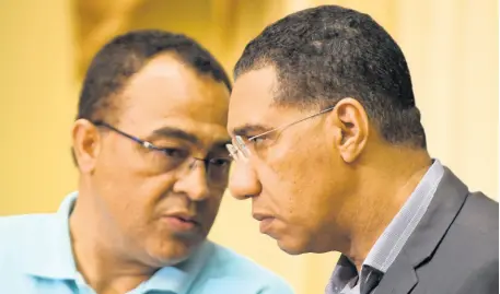  ?? RICARDO MAKYN/CHIEF PHOTO EDITOR ?? Health and Wellness Minister Dr Christophe­r Tufton engages in a tête-à-tête with Prime Minister Andrew Holness at a Jamaica House press briefing, where the prime minister declared the island a disaster area yesterday.