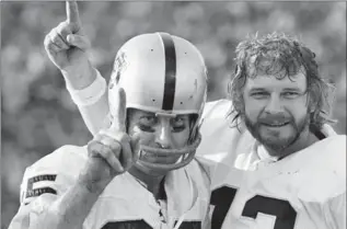  ?? ASSOCIATED PRESS FILE PHOTO ?? In this Jan. 9, 1977, photo, receiver Fred Biletnikof­f, left, and quarterbac­k Ken Stabler of the Oakland Raiders proudly hold up one finger indicating their team is No. 1 after defeating the Minnesota Vikings in the Super Bowl.