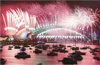  ?? DAVID GRAY/GETTY-AFP ?? New Year’s Eve fireworks light up the sky Sunday over the Opera House and Harbor Bridge in Sydney.