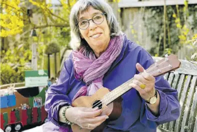  ?? BILD: Werner Fademrecht ?? Sybille Gimon auf einer Bank im Garten: Sie hat die Zwangspaus­e genutzt, Ukulele spielen zu lernen.