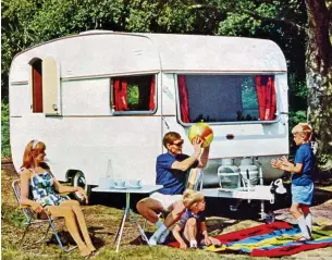  ??  ?? Having a ball: Picnic rug, deckchairs...classic 1968 family holiday scene