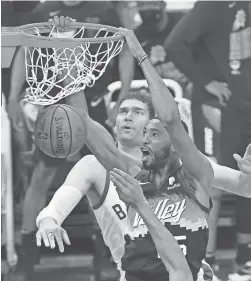  ?? CHOW/ARIZONA REPUBLIC
MICHAEL ?? Suns forward Mikal Bridges (25) dunks against Milwaukee Bucks center Brook Lopez (11) during Game 2 of the NBA Finals at Phoenix Suns Arena.