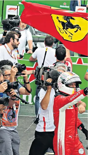  ??  ?? Forza Ferrari: Sebastian Vettel is given a hero’s welcome after his triumph