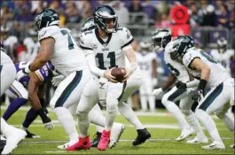  ?? BRUCE KLUCKHOHN — THE ASSOCIATED PRESS ?? Philadelph­ia Eagles quarterbac­k Carson Wentz (11) hands the ball off during the first half of an NFL football game against the Minnesota Vikings, Sunday.