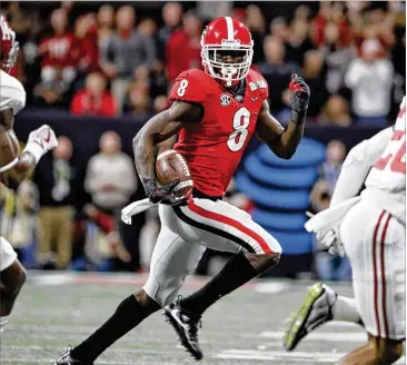  ?? BOB ANDRES / BANDRES@AJC.COM ?? Georgia wide receiver Riley Ridley makes a gain in January’s national championsh­ip game against Alabama. The Bulldogs are No. 3 in the preseason Associated Press poll.