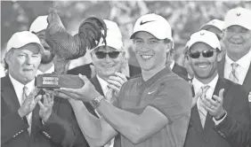  ?? CHRIS TODD/FOR THE CLARION LEDGER ?? Cameron Champ hoists the tournament trophy Reveille after his first PGA Tour win in the Sanderson Farms Championsh­ip.