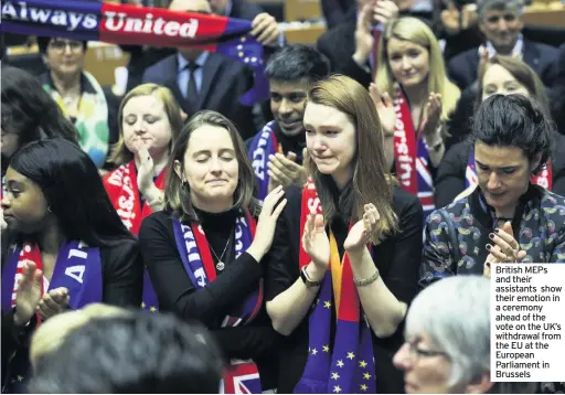  ??  ?? British MEPs and their assistants show their emotion in a ceremony ahead of the vote on the UK’s withdrawal from the EU at the European Parliament in Brussels