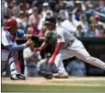  ?? NICK WASS — ASSOCIATED PRESS ?? Red Sox’s Rafael Devers, right, slides home to score past Nationals catcher Pedro Severino on Jackie Bradley Jr.’s sacrifice fly by Jackie Bradley Jr. in the seventh inning of Wednesday’s game at Washington.