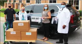  ?? SUBMITTED ?? From left, Lance Landers, co-owner, Mark Martin Kia; Michele Wood, White River Health System marketing director; Jennifer Sandage, outpatient associate chief nursing officer; and Dr. Gilbert Roy Kamoga, Internal Medicine Residency Program director, pose for a photo after White River Medical Center received Mark Martin Kia’s donation of more than 100 face shields for medical workers.