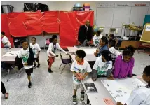  ?? HYOSUB SHIN / HSHIN@AJC.COM ?? Clayton Schools Superinten­dent Morcease J. Beasley visits students and staff at Camp Invention, a STEM summer camp, at Callaway Elementary School in Jonesboro on June 13. Beasley has become the new face of the school district.