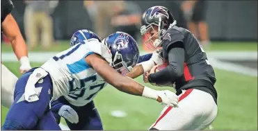  ?? Dale Zanine-usa today sports ?? Tennessee Titans linebacker Derick Roberson (50) and defensive tackle Trevon Coley (97) sack Atlanta Falcons quarterbac­k AJ McCarron at Mercedes-Benz Stadium on Friday in Atlanta.