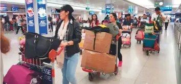  ?? Pictures: Janice Ponce de Leon/Gulf News ?? Some of the 100 repatriate­d Filipinos, including six minors, at Dubai airport yesterday.