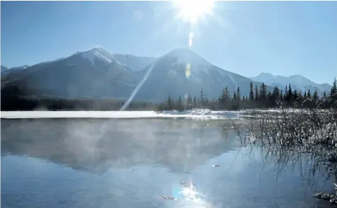  ?? POSTMEDIA NETWORK FILES ?? Mist rolls off a patch of water kept ice free by hot springs at Vermilion Lakes near Banff, Alta.