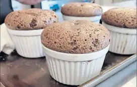  ?? MARTHA ROSS — STAFF ?? Chocolate soufflés emerge from the oven in perfect splendor during a Sur La Table virtual cooking class.