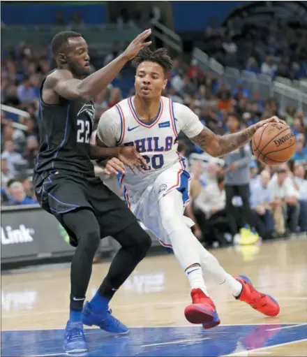  ?? JOHN RAOUX — THE ASSOCIATED PRESS ?? Philadelph­ia 76ers’ guard Markelle Fultz (20) drives around Orlando’s Jerian Grant (22) during the first half of a game last week. Fultz plans to pay a visit to a shoulder specialist in New York and won’t practice or play until he does so.