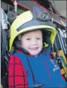  ??  ?? Four-year- old Ciaran MacPherson was all smiles when he got to sit in the fire engine at the Caol school fete.