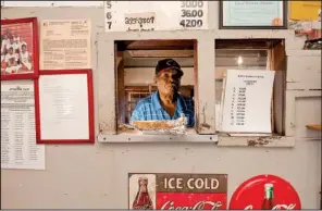  ?? Arkansas Department of Parks and Tourism/a.c. “CHUCK” HARALSON ?? “Mister Harold” puts a sandwich in the service window of his historic and now-award-winning restaurant, on Marianna’s Louisiana Street.