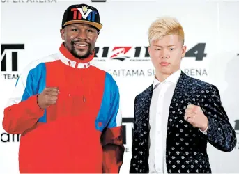  ??  ?? Unbeaten boxer Floyd Mayweather poses with his opponent Tenshin Nasukawa at a news conference, where the American announced he was joining Japanese MMA promotiona­l company Rizin Fighting Federation, in Tokyo yesterday. — Reuters