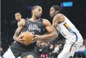  ?? FRANK FRANKLIN II AP ?? Clippers’ Kawhi Leonard, who finished with 24 points, spins past Nets’ Edmond Sumner on Monday.