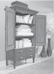  ?? Creators Syndicate photo ?? A great place to store out-of-season clothes or extra bedding is an armoire that sits in your living room.