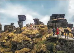  ?? YANG ENUO / FOR CHINA DAILY ?? Unusual rock formations attract tourists at Mount Fanjingsha­n in Guizhou province. The shape is a result of longtime weathering.