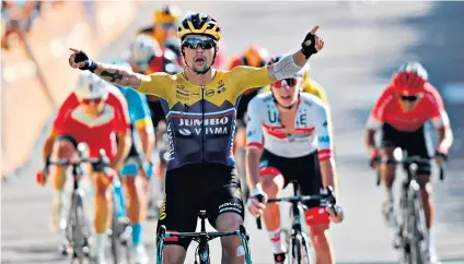  ??  ?? No contest: Jumbo-visma’s Primoz Roglic celebrates as he crosses the finish line to win the fourth stage